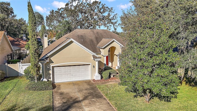 view of front of property with a front yard and a garage