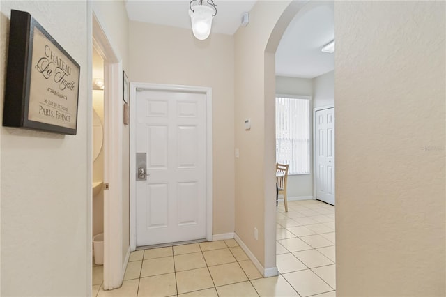 hall featuring light tile patterned floors