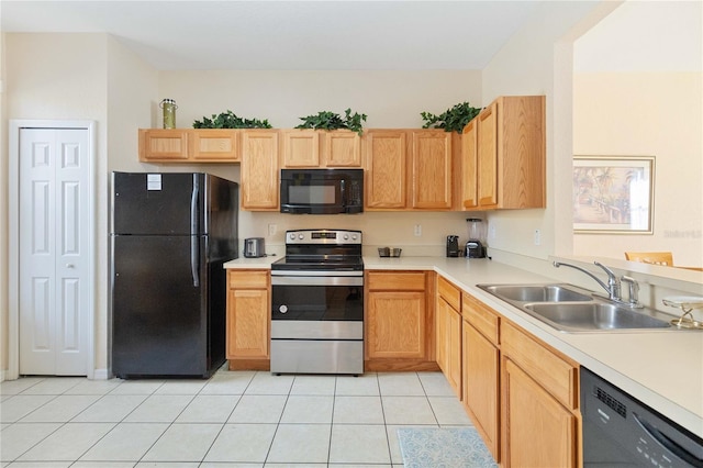 kitchen with light brown cabinetry, sink, light tile patterned floors, and black appliances