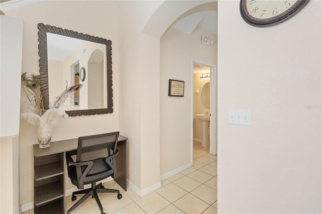 hall with light tile patterned floors