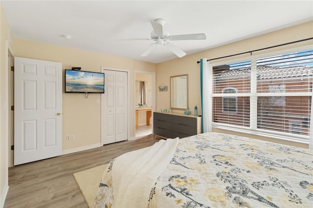 bedroom featuring ensuite bath, ceiling fan, a closet, and light wood-type flooring