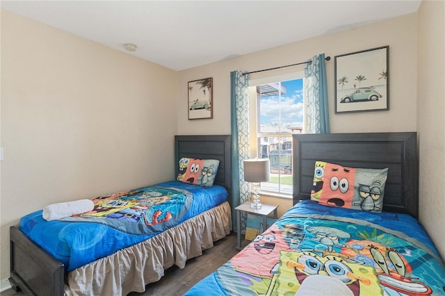 bedroom with dark hardwood / wood-style floors