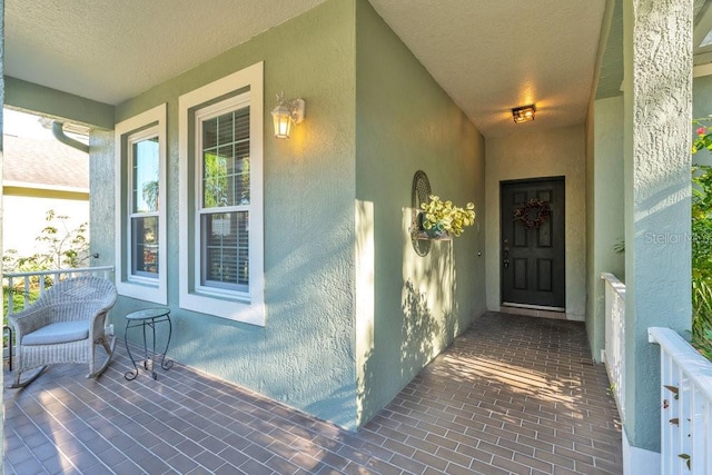 entrance to property featuring covered porch