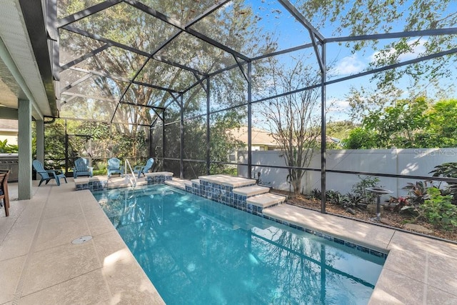 view of swimming pool featuring glass enclosure and a patio