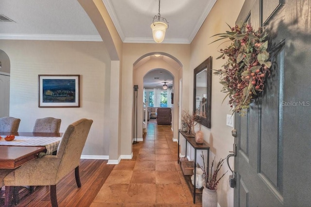 foyer with ceiling fan, light hardwood / wood-style floors, and crown molding