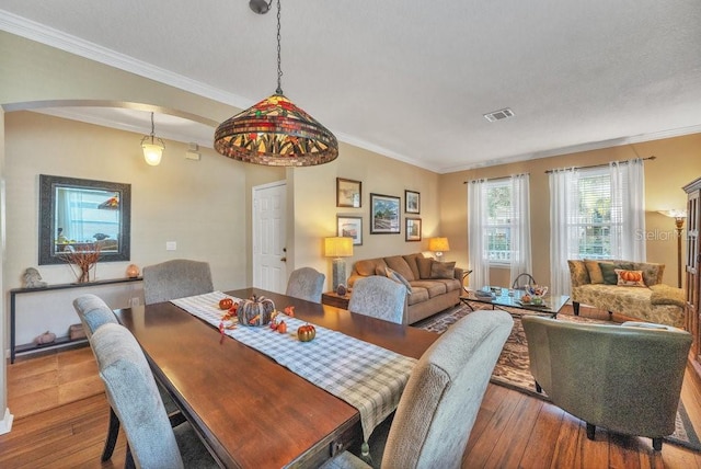 dining room featuring hardwood / wood-style flooring and crown molding