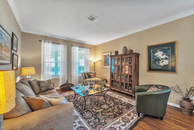 living room with crown molding and hardwood / wood-style flooring