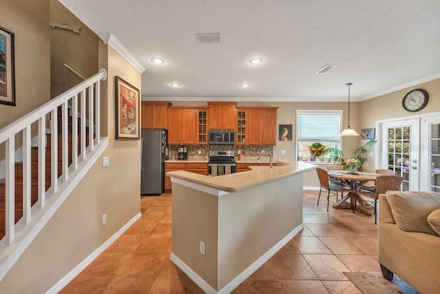 kitchen with decorative backsplash, appliances with stainless steel finishes, ornamental molding, a textured ceiling, and pendant lighting