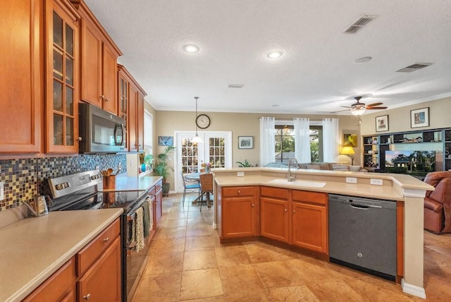 kitchen featuring appliances with stainless steel finishes, ceiling fan, crown molding, sink, and pendant lighting