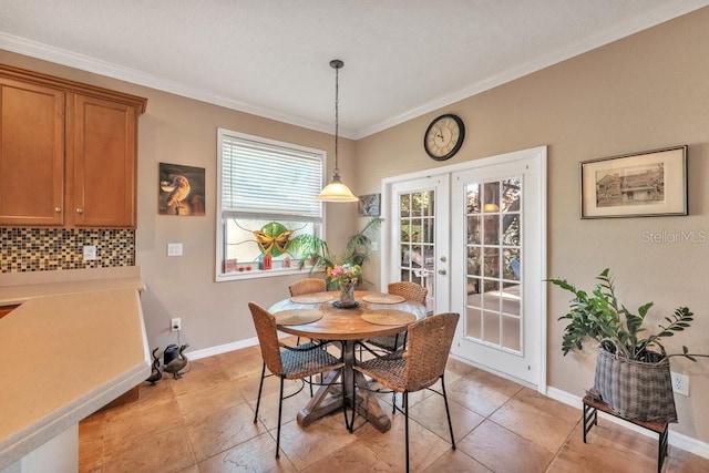 dining space with crown molding and french doors