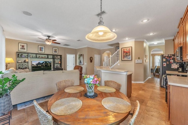 dining room with ceiling fan and ornamental molding