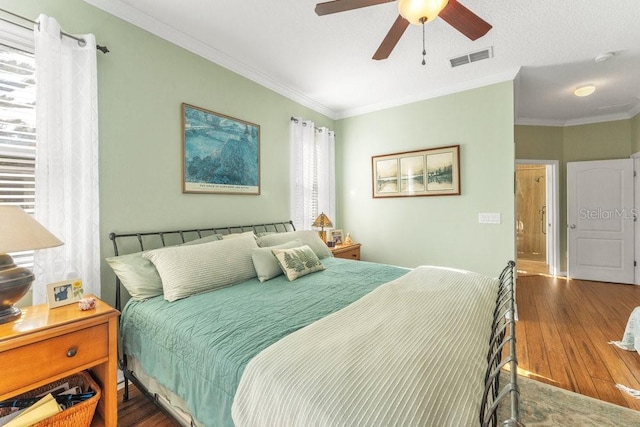 bedroom with ceiling fan, dark hardwood / wood-style flooring, and crown molding