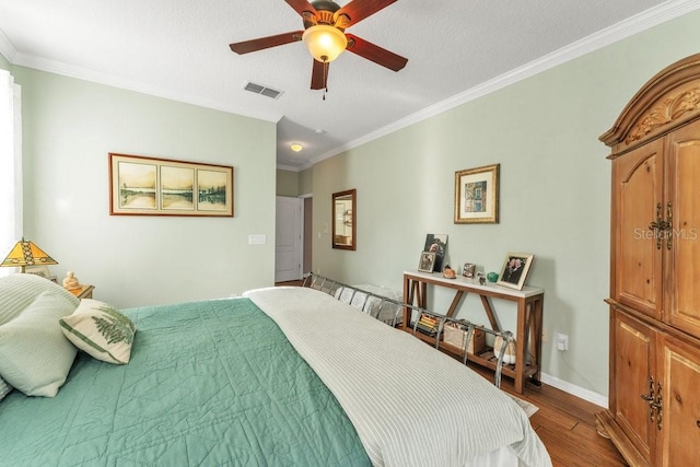 bedroom with ceiling fan, crown molding, a textured ceiling, and hardwood / wood-style flooring