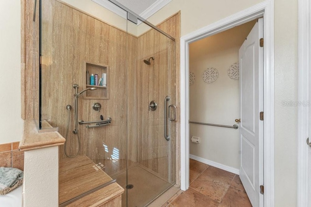 bathroom featuring a shower with door and crown molding