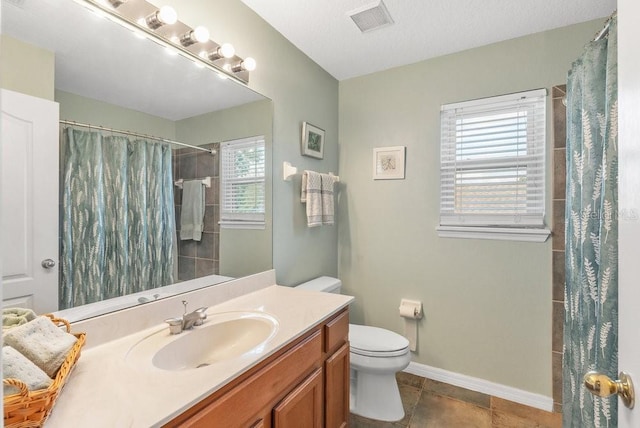 bathroom featuring tile patterned flooring, vanity, curtained shower, and toilet