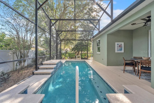 view of swimming pool featuring ceiling fan and a patio