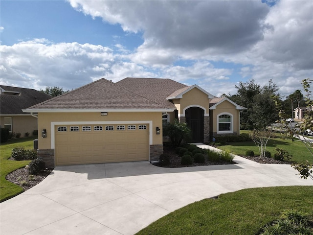 view of front of property featuring a garage and a front lawn