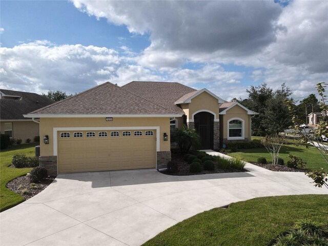 1010 Nantucket Sound, Mount Dora, FL 32757 - view of front facade with stucco siding, concrete driveway, an attached garage, and a front lawn