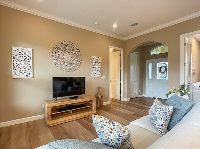 living room featuring crown molding and hardwood / wood-style floors