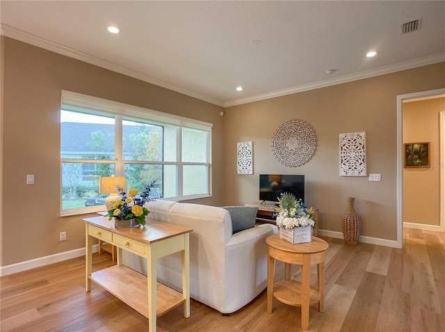 living room with light hardwood / wood-style floors and crown molding