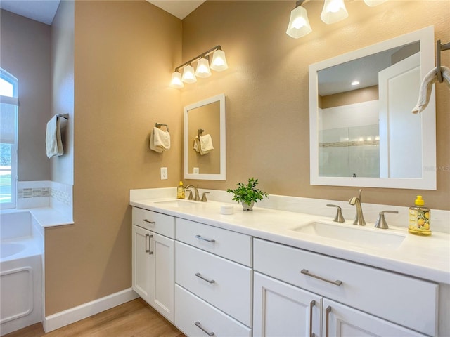 bathroom featuring hardwood / wood-style floors, vanity, and a tub