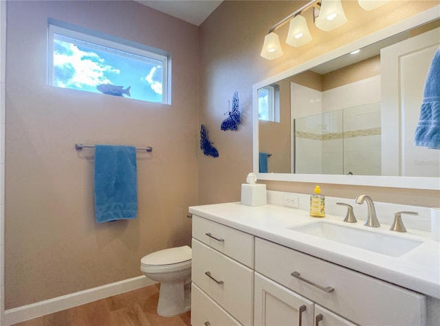 bathroom featuring vanity, hardwood / wood-style flooring, toilet, and walk in shower