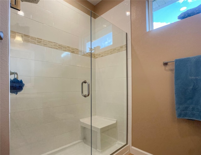 bathroom with a shower with door