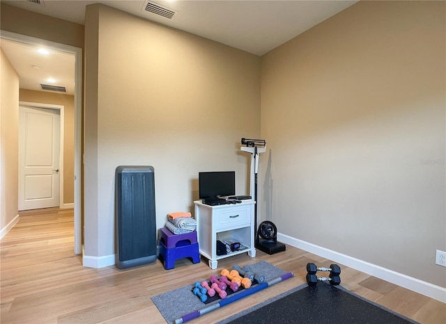 workout room featuring light hardwood / wood-style floors