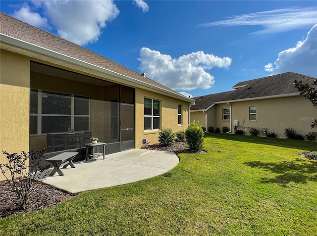 back of house featuring a patio area and a lawn