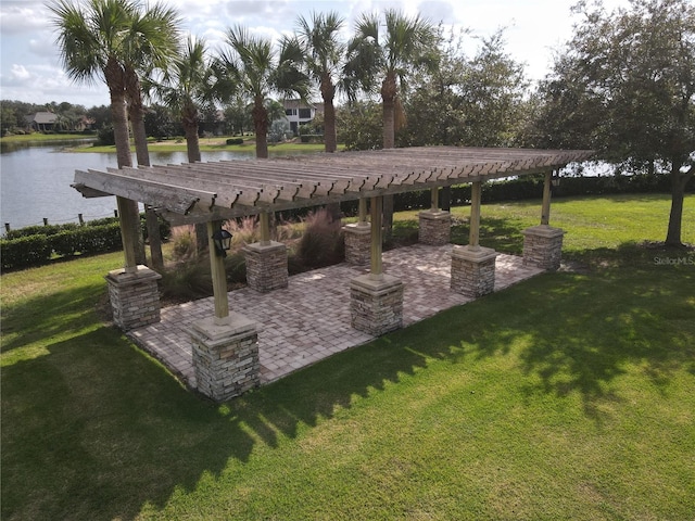 exterior space featuring a patio area, a water view, and a pergola