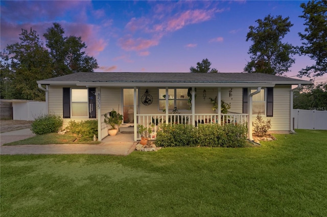 view of front of property with a yard and a porch