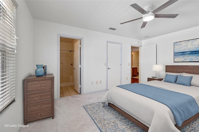 bedroom with ensuite bath and ceiling fan