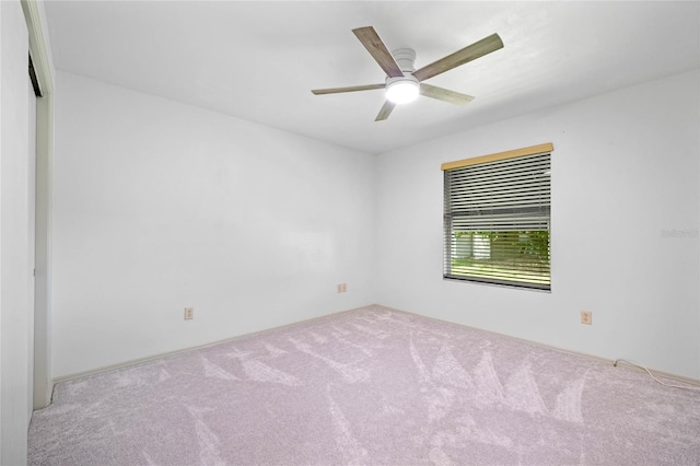 empty room with ceiling fan and carpet floors