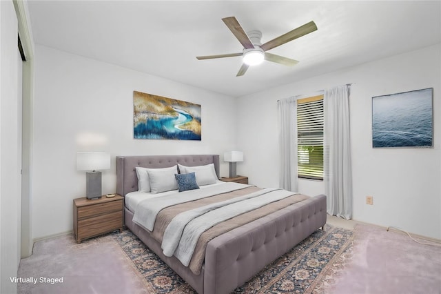 bedroom with ceiling fan and light carpet