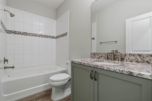 full bathroom featuring vanity, toilet, and tiled shower / bath combo