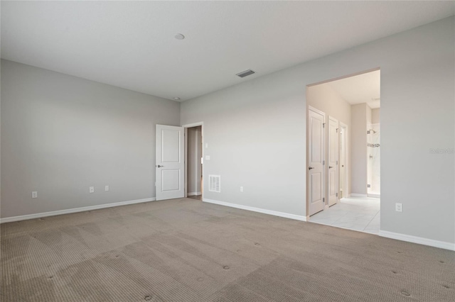 empty room featuring light carpet