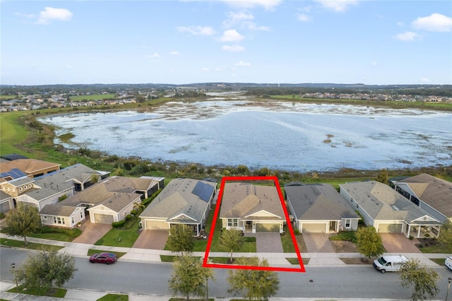 birds eye view of property with a water view