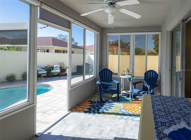 sunroom featuring ceiling fan