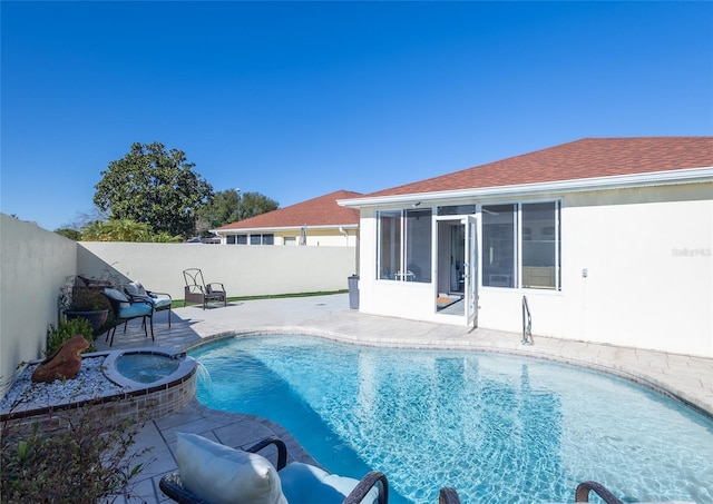 view of pool featuring a sunroom, an in ground hot tub, and a patio area