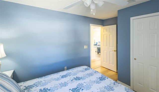 bedroom with ceiling fan and light hardwood / wood-style floors