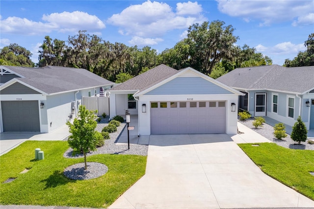 single story home with a front lawn and a garage