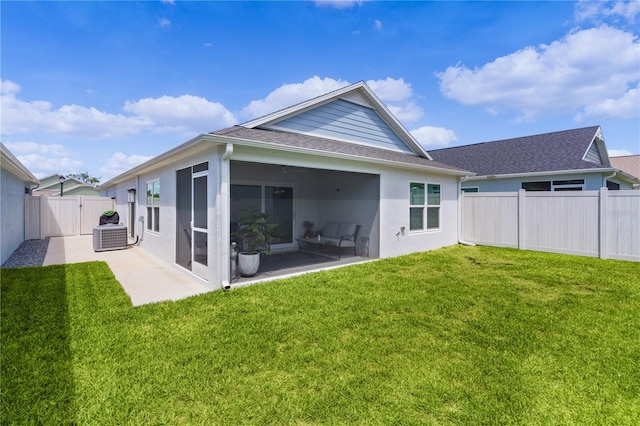 back of property featuring a sunroom and a yard