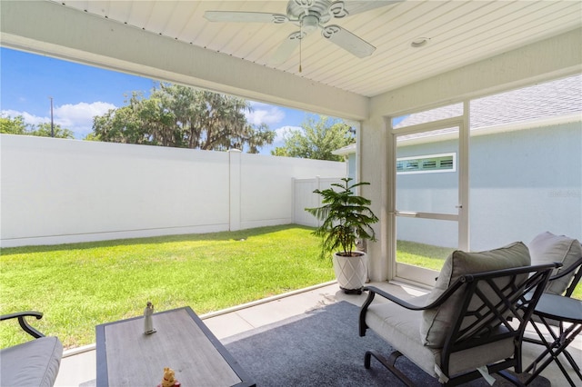 sunroom with ceiling fan and wooden ceiling