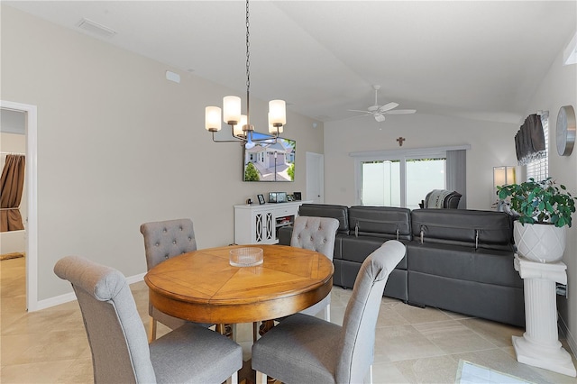 tiled dining space with ceiling fan with notable chandelier and lofted ceiling