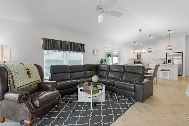 tiled living room featuring ceiling fan, sink, and vaulted ceiling