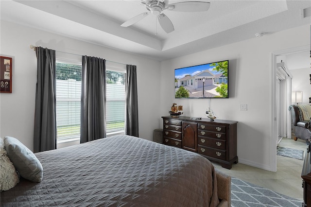 bedroom with ceiling fan, light tile patterned flooring, and a textured ceiling