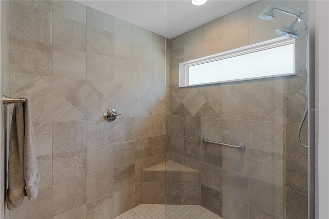 bathroom with tiled shower