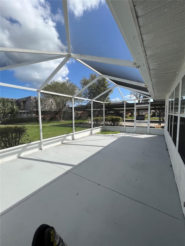 view of patio with glass enclosure