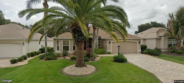 view of front of house featuring a garage and a front lawn