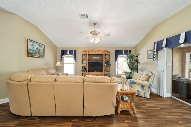 living room with a textured ceiling, dark hardwood / wood-style floors, vaulted ceiling, and ceiling fan